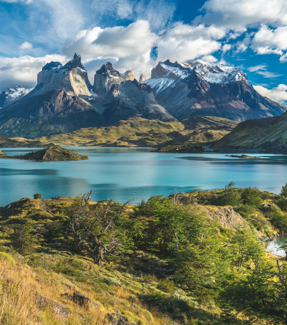 Panoramic Torres del Paine peaks rising over turquoise lake, Chile