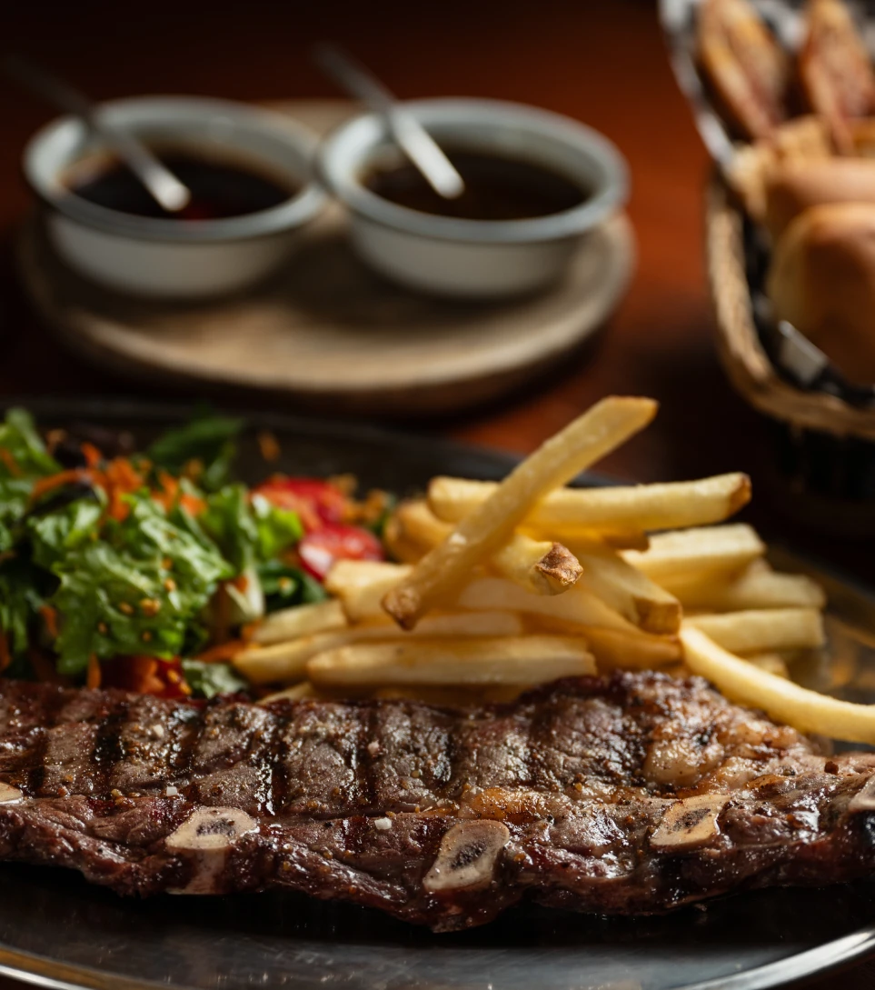 Argentine asado steak with chimichurri and fries