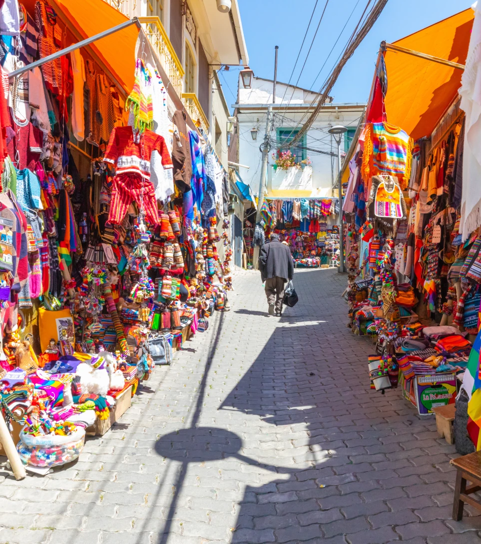 Colorful Bolivian market alley with textiles