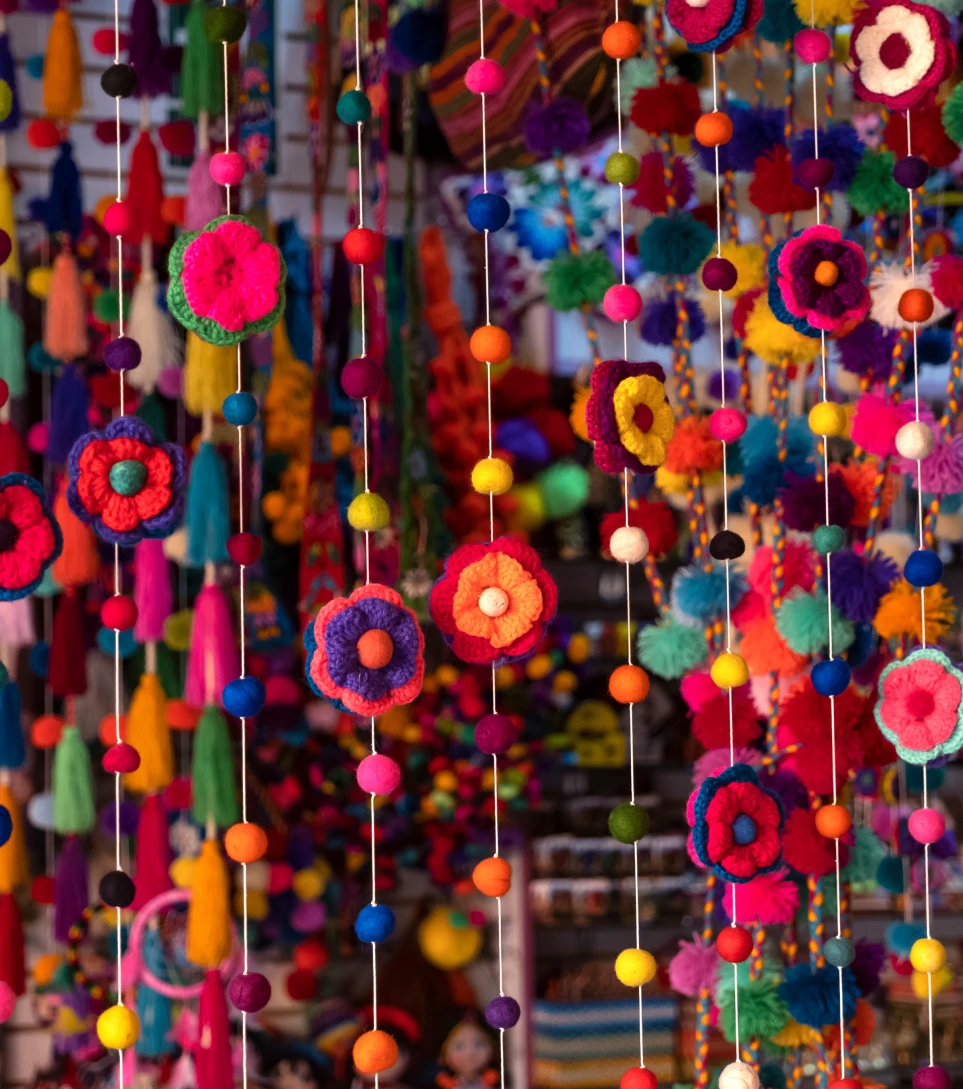 Colorful Andean textile decorations hanging in a market