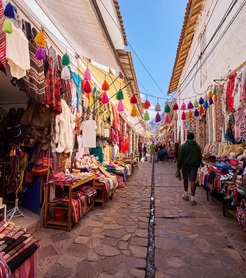 Colorful Cusco market alley with textiles and souvenirs